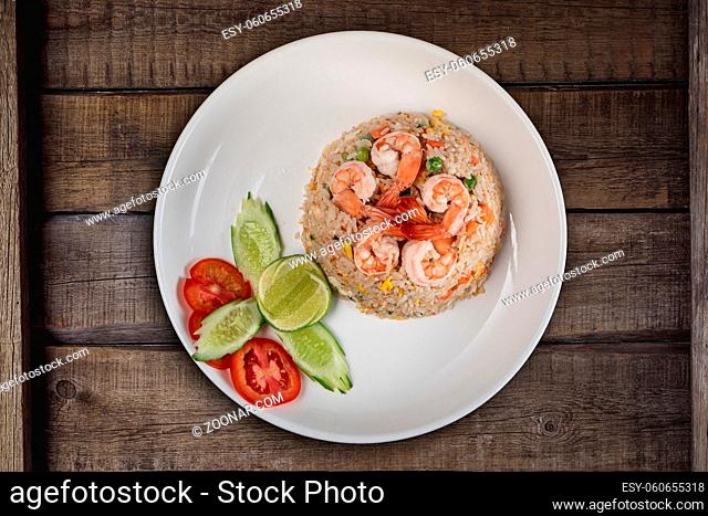 Top view Thai food shrimp fried rice isolated on rustic wooden table
