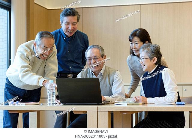 Senior people enjoying using PC