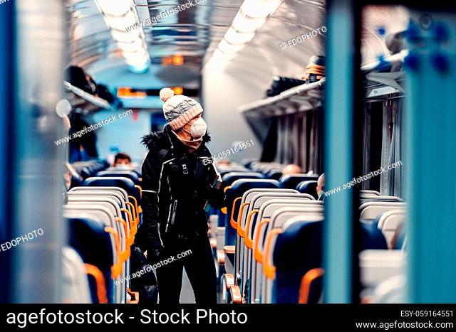 young woman with a face mask in a train at the time of the coronavirus. covid-19