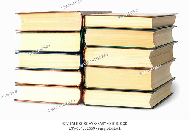 Two stacks of old books rotated isolated on white background