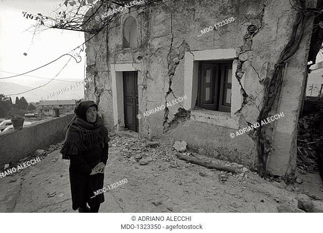A woman in front of the collapse of her house. A woman in front of the collapse of her house after the earthquake. Irpinia, November 1980