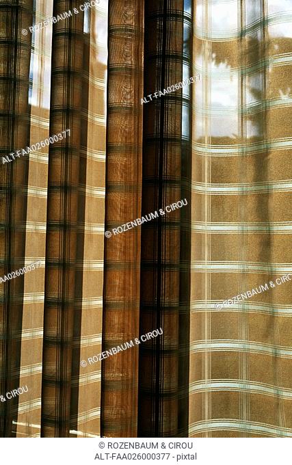 Plaid curtains in window, full frame