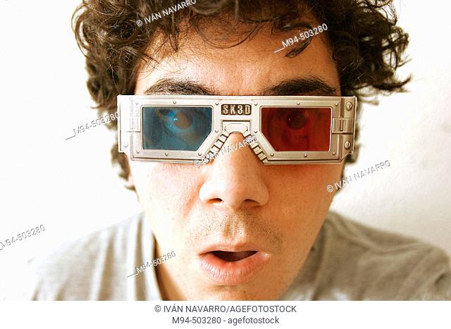 Man with 3D glasses looking to something surprised