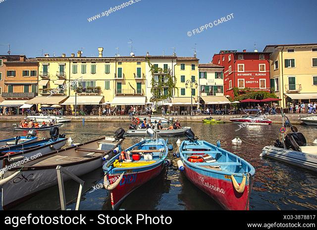 LAZISE, ITALY: Dogana Veneta and Porticciolo in Lazise, in Italy with colored boats