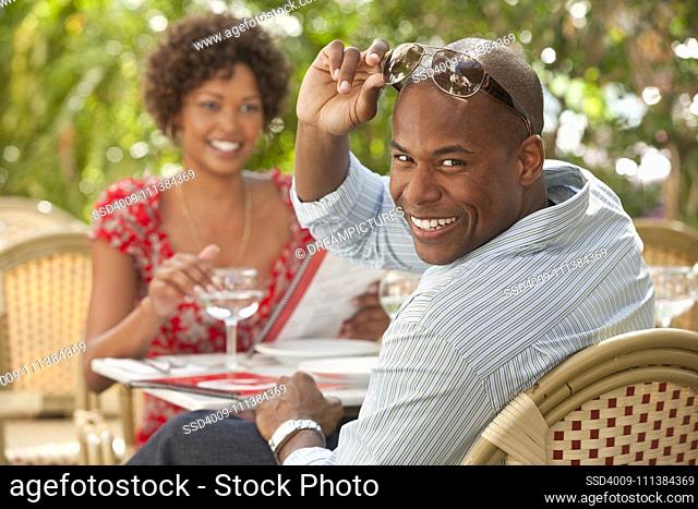 African American couple eating in restaurant