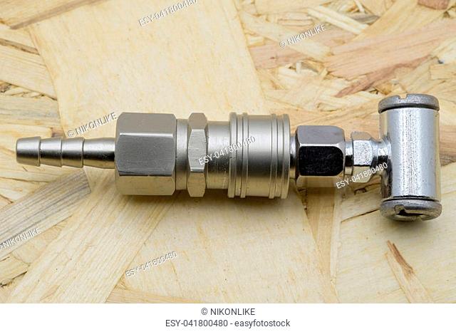 Air coupling connector, Pneumatic fitting on wood background