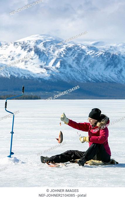 Woman ice fishing