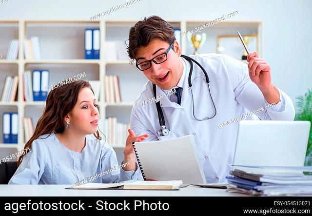 Female patient visiting male doctor for regular check-up in hospital clinic