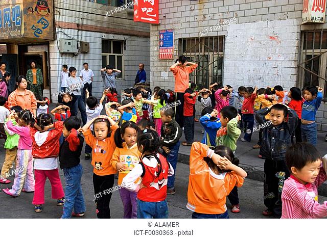 China, Xinjiang, Urumqi, schoolgirls, physical education