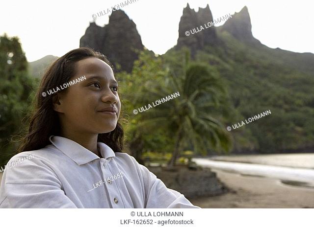 Girl in front of peaks at Hatiheu, Nuku Hiva, Marquesas, Polynesia, Oceania