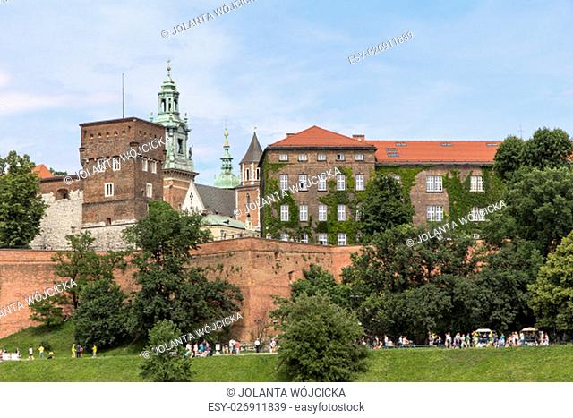 KRAKOW, POLAND - JUNE 17, 2013 : View on Wawel Royal Castle and Vistula boulevards. Place often visited by tourists and locals for purposes of relaxation on...