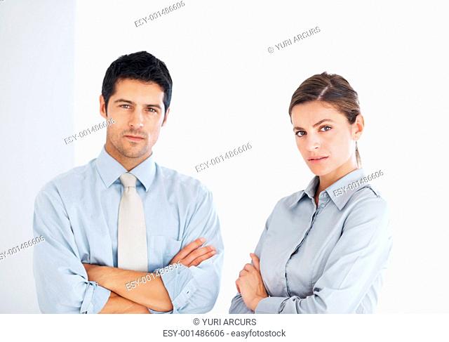 Portrait of confident business man and woman with hands folded on white background