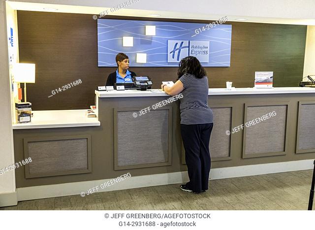 Georgia, St. Simons Island, Holiday Inn Express, hotel, front desk, check-in, clerk, guest, Black, woman, employee, job, service