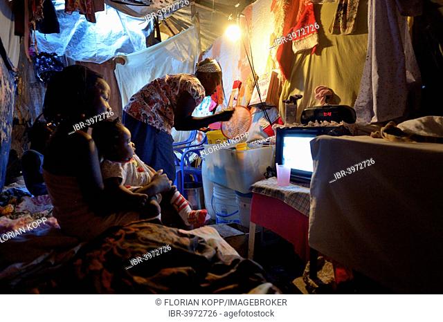 Woman and children in a ramshackle hut, Camp Icare, camp for earthquake refugees, Fort National, Port-au-Prince, Haiti