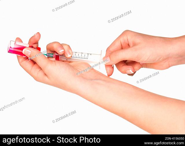 Woman hands with syringe and vial of medication isolated on white background