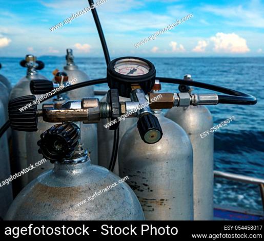 Diving equipment. Gas cylinders on sea backdrop, close-up