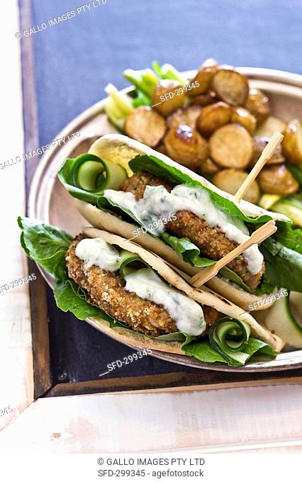 Pita bread filled with fish cakes and tzatziki