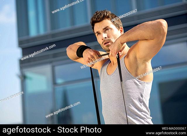 Portrait of man training with fitness band