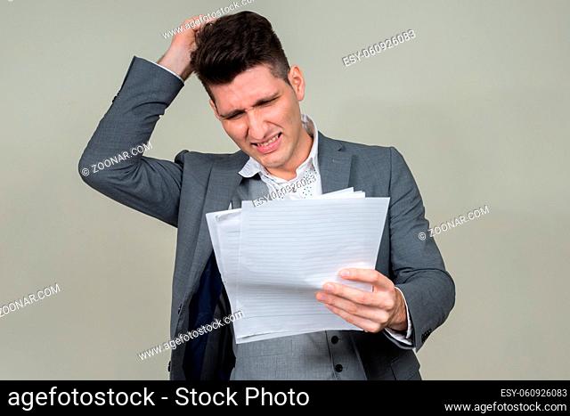 Studio shot of young multi ethnic businessman against white background