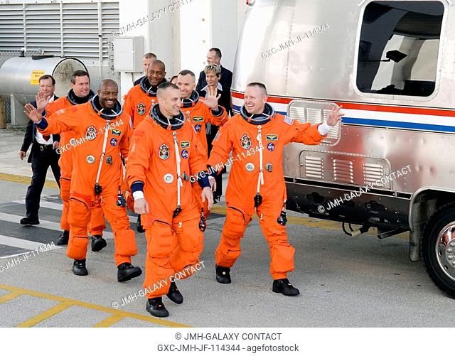 After suiting up, the STS-129 crew members exit the Operations and Checkout Building to board the Astrovan, which will take them to launch pad 39A for the...