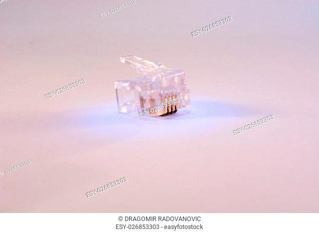 Single RJ-45 connector on white background. Connector is translucent and it is colored with blue light