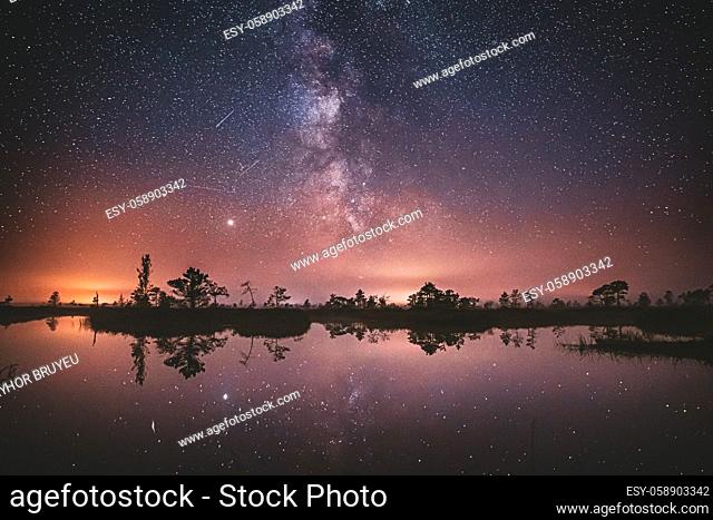 Lake Nature Landscape. Night Starry Sky Milky Way Galaxy With Glowing Stars And Moon. Nature Night Sky Reflection In Water