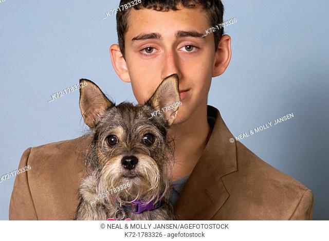 Funny portrait of dog and young teenage man