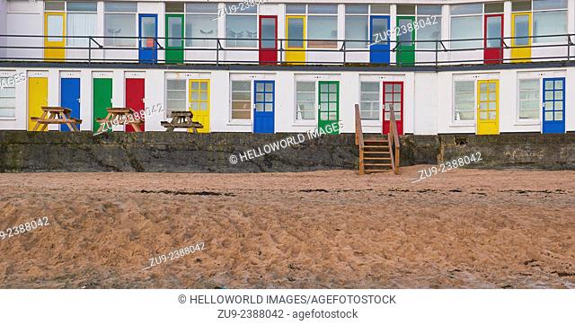 Traditional beach huts with bright coloured painted doors, Porthgwidden Beach, St Ives, Cornwall, England, Europe