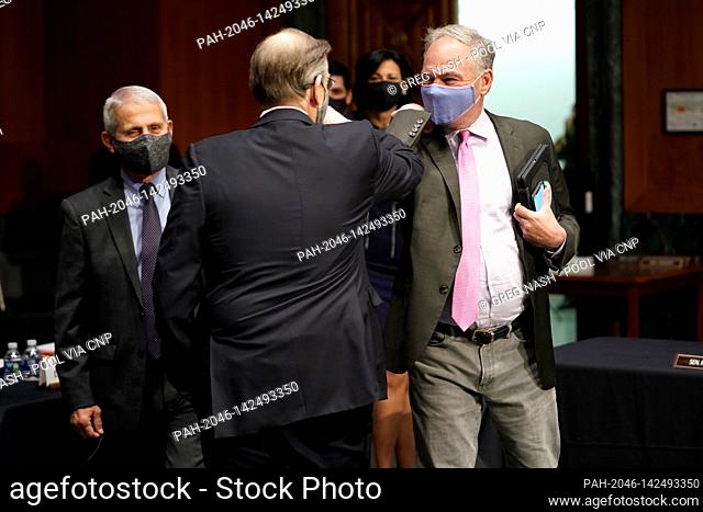 United States Senator Tim Kaine (Democrat of Virginia) elbow bumps Department of Health and Human Services Chief Science Officer for Covid Response David...