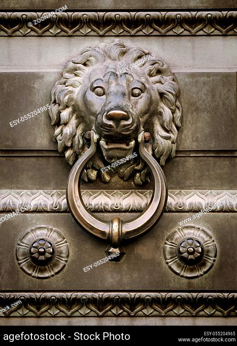 Old lion head door knocker sepia toned