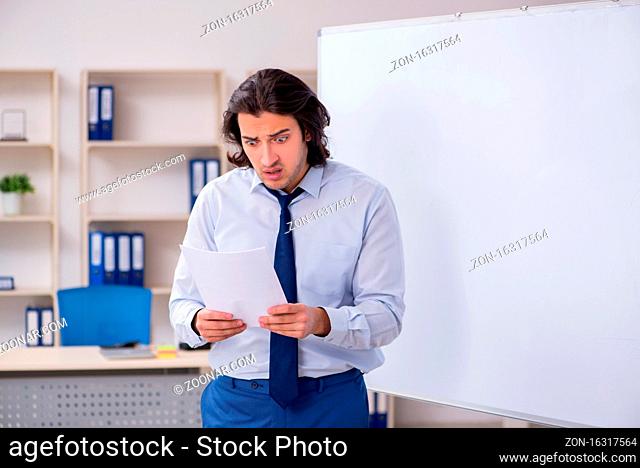 Young man employee presenting in the office