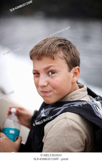 Teenage boy drinking from water bottle