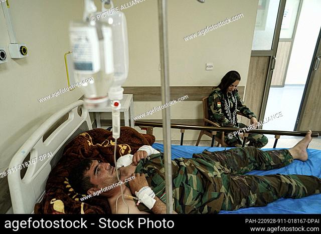 28 September 2022, Iraq, Erbil: A wounded member of the opposition Kurdistan Freedom Party (PAK) lies on a bed at a hospital following attacks by Iranian...