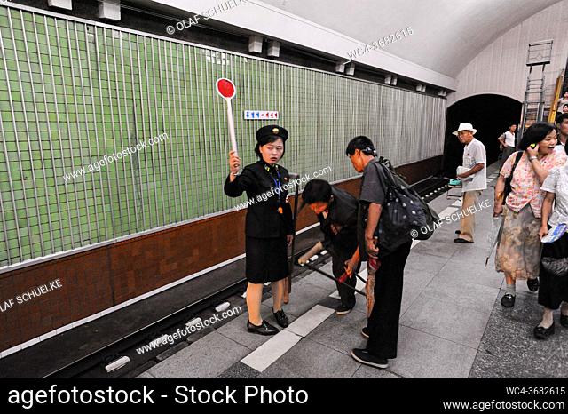 Pyongyang, North Korea, Asia - A female platform attendant signals at an underground station of the Pyongyang Metro in the North Korean capital city