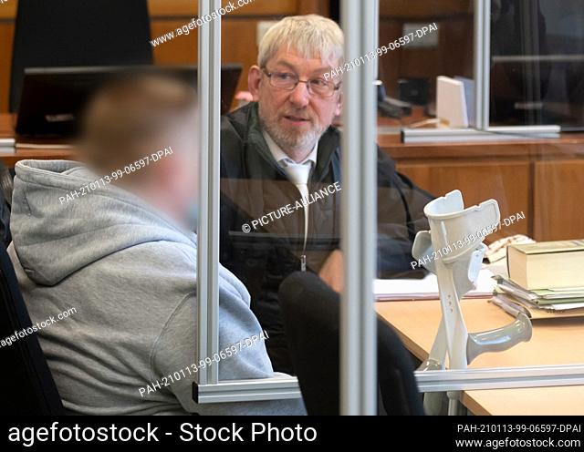 13 January 2021, North Rhine-Westphalia, Hagen: The defendant (l) sits with crutches next to his defense lawyer Andreas Trode in the district court