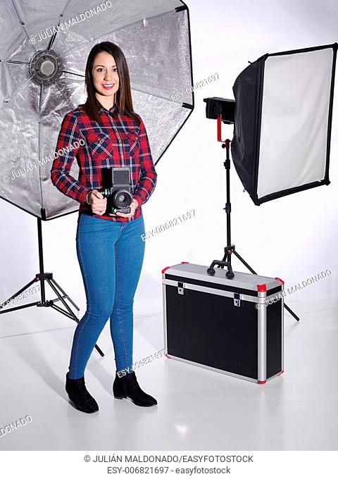 Female photographer in his studio and their kits