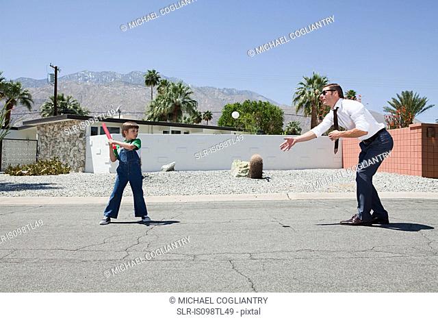 Father playing ball with son