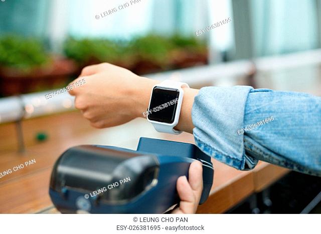 Customer using wearable watch to pay