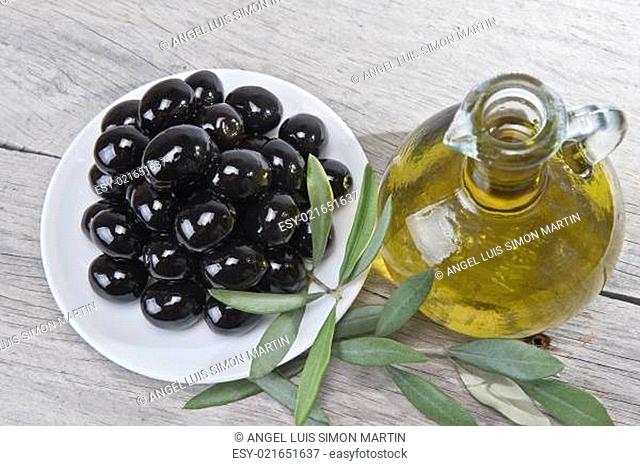 A plate with black olives and oil