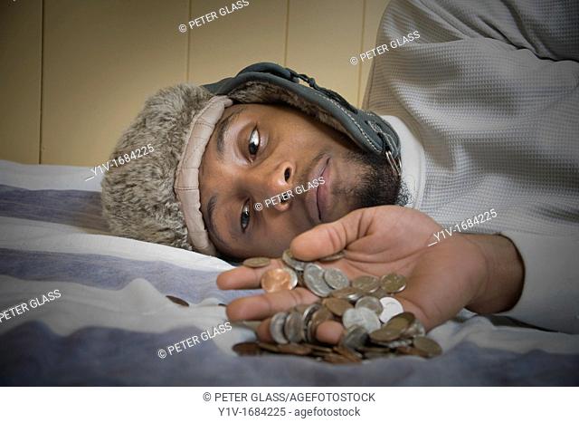 Young black man with United States coins