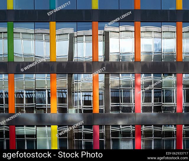Brussels European Quarter, Belgium - March 15, 2023 - Colorful patterns of looking glass of a contemporary office building