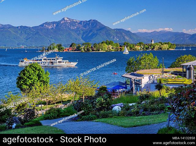 excursion boat in front of gardens on the lakeshore towards fraueninsel and hochgern (1748m), gstadt, chiemsee, chiemgau, upper bavaria, bavaria, germany