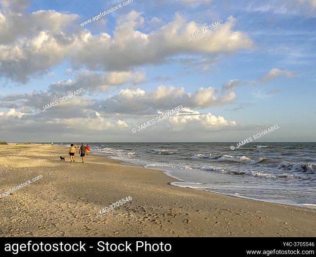 People walking on Gulf of Mexico beach on Sanibel Island Florida in the United States