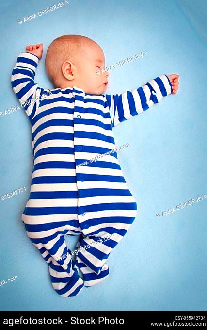 little boy sleeping on soft blue blanket