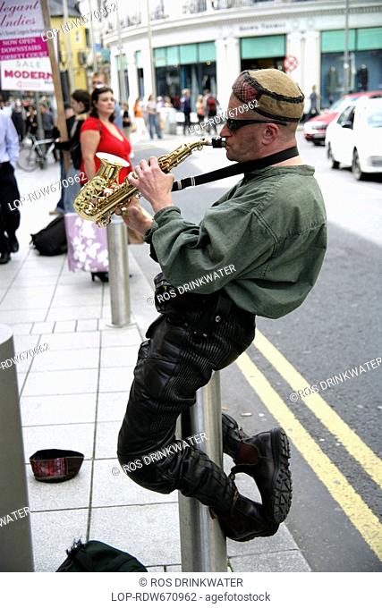 Republic of Ireland, County Galway, Galway, A busker performing with his saxaphone in Galway City