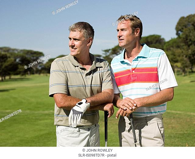 Two mature men playing golf together