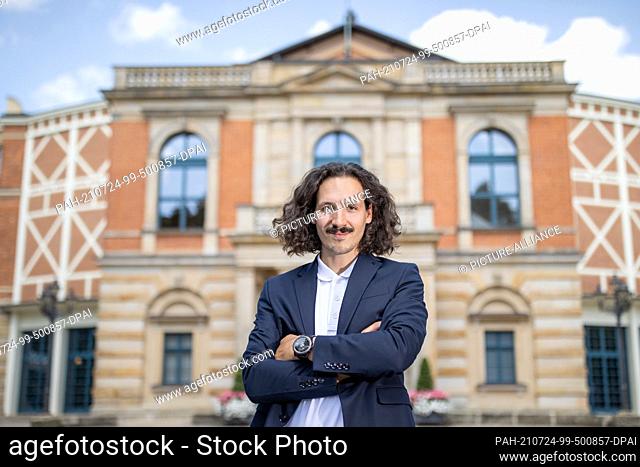 23 July 2021, Bavaria, Bayreuth: The director Valentin Schwarz stands in front of the Festspielhaus. The ""Ring"" director Schwarz