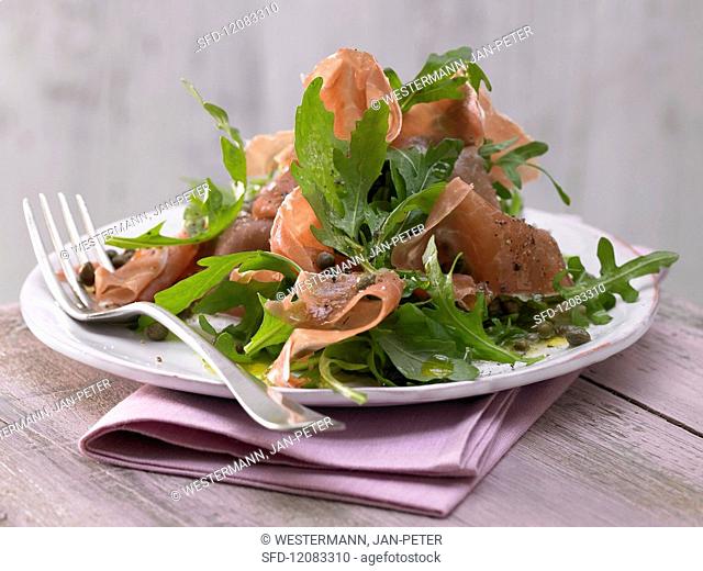 Rocket salad with Parma ham and caper dressing