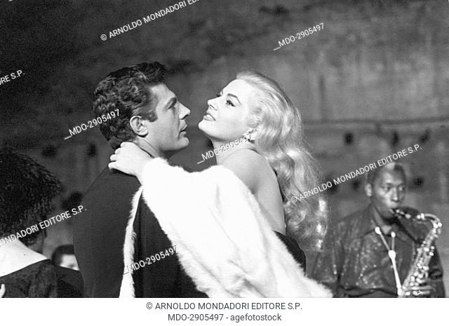 Swedish-born Italian actress Anita Ekberg and Italian actor Marcello Mastroianni hugging each other in a scene from the film La dolce vita. Rome, 1960