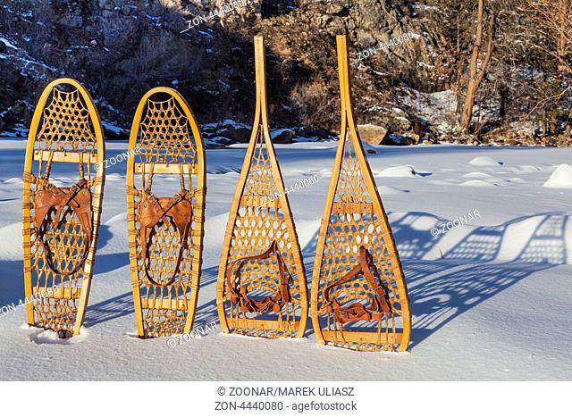 vintage Bear Paw and Huron snowshoes cast shadow in snow, Poudre River Canyon near Fort Collins, Colorado